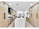 Spacious kitchen featuring stainless steel appliances, stylish cabinetry, marble countertops, and a large center island at 7685 Spanish Bay Dr, Las Vegas, NV 89113