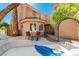 Outdoor patio featuring a lounge bed and seating with beautiful landscaping and a covered entrance at 7685 Spanish Bay Dr, Las Vegas, NV 89113