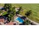 Aerial view of backyard pool and patio with mature landscaping and golf course in the background at 7685 Spanish Bay Dr, Las Vegas, NV 89113