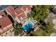 Aerial view of a private backyard pool with mature landscaping and a cozy outdoor seating area at 7685 Spanish Bay Dr, Las Vegas, NV 89113