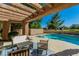 Backyard view of in-ground pool, hot tub, outdoor seating and a clear view of the adjacent golf course at 7685 Spanish Bay Dr, Las Vegas, NV 89113