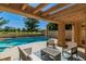 Backyard view of in-ground pool, hot tub, outdoor seating and a clear view of the adjacent golf course at 7685 Spanish Bay Dr, Las Vegas, NV 89113