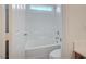 Bright white bathroom featuring a shower over bath, tile backsplash and chrome fixtures at 8027 Anasazi Ranch Ave, Las Vegas, NV 89131