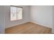 Bedroom featuring hardwood floors, neutral walls, base trim, and a large window at 8027 Anasazi Ranch Ave, Las Vegas, NV 89131