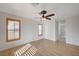 Bright bedroom with wood-look flooring, ceiling fan, and two windows at 8027 Anasazi Ranch Ave, Las Vegas, NV 89131