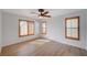 Bedroom with wood floors, ceiling fan, and shuttered windows at 8027 Anasazi Ranch Ave, Las Vegas, NV 89131