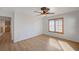 Light-filled bedroom with wood-look flooring, ceiling fan, and wooden shutters at 8027 Anasazi Ranch Ave, Las Vegas, NV 89131