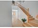 Bright entryway with wood-look floors, soaring ceilings, and an open staircase at 8027 Anasazi Ranch Ave, Las Vegas, NV 89131