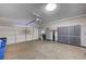 Spacious garage with painted walls, concrete floor and storage cabinets at 8027 Anasazi Ranch Ave, Las Vegas, NV 89131