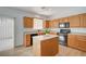 Bright kitchen with an island, stainless steel appliances, and sliding glass door at 8027 Anasazi Ranch Ave, Las Vegas, NV 89131