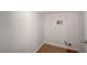 A simple, white laundry room with wood floor and wire shelving at 8027 Anasazi Ranch Ave, Las Vegas, NV 89131