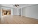 Open-concept living room boasts wood floors connecting to the kitchen and a ceiling fan at 8027 Anasazi Ranch Ave, Las Vegas, NV 89131