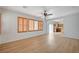 Bright living room featuring wood-look floors, shuttered windows, and a ceiling fan at 8027 Anasazi Ranch Ave, Las Vegas, NV 89131