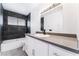 Modern bathroom features black marble-look tile accent wall and updated vanity with gray countertop at 804 Vincent Way, Las Vegas, NV 89145