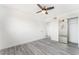 Bright bedroom features sleek ceiling fan, wood-look floors, and mirrored closet at 804 Vincent Way, Las Vegas, NV 89145