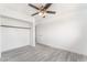 This bedroom shows a ceiling fan, wood-look floors, and a closet with sliding doors at 804 Vincent Way, Las Vegas, NV 89145