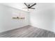 This bedroom features wood-look floors, a ceiling fan and a window looking out to a view at 804 Vincent Way, Las Vegas, NV 89145