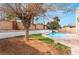 Backyard pool featuring clear blue water, surrounded by stone and desert landscaping at 804 Vincent Way, Las Vegas, NV 89145