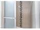 Shower featuring decorative stone-look accent tile with a glass door at 804 Vincent Way, Las Vegas, NV 89145