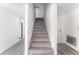 A clean, modern stairway with hard surface stairs, white walls, and nearby appliances at 804 Vincent Way, Las Vegas, NV 89145