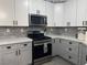 Light and airy kitchen features gray cabinets, stainless steel appliances, gray subway tile backsplash, and ample counter space at 807 Zinnia Cir, Henderson, NV 89015