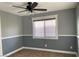 Bedroom with a ceiling fan, carpet, and gray two-tone paint scheme with white trim at 8212 Cabin Springs Ave, Las Vegas, NV 89131