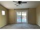 Spacious bedroom featuring a ceiling fan and sliding glass door access to the pool and patio at 8212 Cabin Springs Ave, Las Vegas, NV 89131