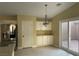 Kitchen showcasing stainless steel appliances, white cabinets and countertops, with a large sliding door at 8212 Cabin Springs Ave, Las Vegas, NV 89131