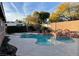 Backyard featuring a pool with a hot tub and a rock waterfall feature at 8212 Cabin Springs Ave, Las Vegas, NV 89131