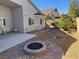 Landscaped backyard features a charming fire pit, patio area, and desert-friendly landscaping at 9204 Gentle Cascade Ave, Las Vegas, NV 89178