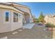 Spacious backyard featuring a stone patio, gravel landscaping, and built-in fire pit at 9204 Gentle Cascade Ave, Las Vegas, NV 89178