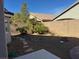 View of the desert landscaped backyard with stone features and partial patio at 9204 Gentle Cascade Ave, Las Vegas, NV 89178