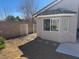 Landscaped backyard with desert landscaping, gravel, partial grass and a block wall at 9204 Gentle Cascade Ave, Las Vegas, NV 89178