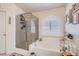 Bathroom features a tiled shower, soaking tub, and picture window with shutters at 9204 Gentle Cascade Ave, Las Vegas, NV 89178