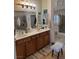 Primary bathroom featuring double sinks, framed mirrors, and a separate glass shower at 9204 Gentle Cascade Ave, Las Vegas, NV 89178