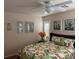 Bright bedroom with ceiling fan, floral bedding, and sunny windows with white shutters at 9204 Gentle Cascade Ave, Las Vegas, NV 89178