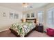 Charming bedroom featuring a queen bed with tropical bedding and shuttered windows at 9204 Gentle Cascade Ave, Las Vegas, NV 89178