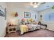 Charming bedroom featuring a daybed, floral bedding, ceiling fan, and natural light at 9204 Gentle Cascade Ave, Las Vegas, NV 89178