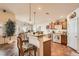 A well-lit kitchen featuring an island, modern appliances, and tiled floors at 9204 Gentle Cascade Ave, Las Vegas, NV 89178