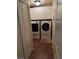 Functional laundry room with white cabinets, a modern washer, and a dryer at 9204 Gentle Cascade Ave, Las Vegas, NV 89178