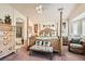 Elegant main bedroom features a four-poster bed, bench, and neutral color palette at 9204 Gentle Cascade Ave, Las Vegas, NV 89178