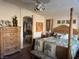 Bright main bedroom with a ceiling fan, tropical bedding, and an en-suite bathroom at 9204 Gentle Cascade Ave, Las Vegas, NV 89178