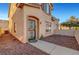 Stucco-clad townhome has a private entrance with security door, desert landscaping, and concrete walkway at 9564 Belle Fountain Ave, Las Vegas, NV 89123