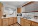 Functional kitchen with wood cabinets, white appliances, and a cozy breakfast bar at 9564 Belle Fountain Ave, Las Vegas, NV 89123