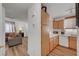 Open kitchen view with wood cabinets, white appliances, and seamless flow to the living area at 9564 Belle Fountain Ave, Las Vegas, NV 89123