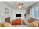 The inviting living room features a fireplace, wood-look flooring, and comfortable sectional seating at 9564 Belle Fountain Ave, Las Vegas, NV 89123