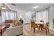 Inviting living room with a comfortable sectional sofa and a round dining table at 9564 Belle Fountain Ave, Las Vegas, NV 89123