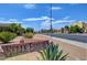 View of Belle Esprit community street with signage, desert landscaping, and various buildings at 9564 Belle Fountain Ave, Las Vegas, NV 89123