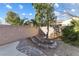 The backyard is landscaped with rock features, plants and a paved walkway at 7400 Quail Heights Ave, Las Vegas, NV 89131