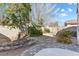 A backyard space with rock landscaping, plants, and a patio at 7400 Quail Heights Ave, Las Vegas, NV 89131